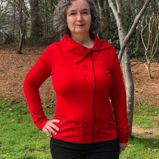 Women's red long sleeve t-shirt hand printed with a black abstract pattern