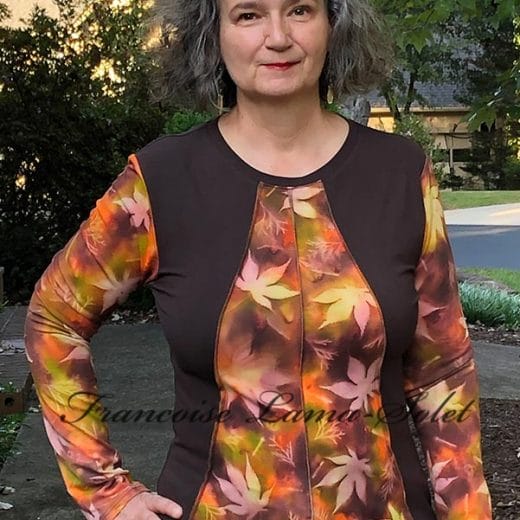 Handmade wearable art top featuring hand-painted bamboo jersey with earthy brown, green, and orange hues, sun-printed with maple and cypress leaf patterns, and paired with solid brown cotton lycra jersey in a feminine, flattering design.