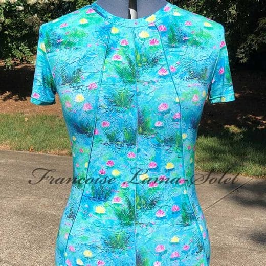 Handmade women's short-sleeve top featuring a vibrant waterlily design with shades of blue, pink, and yellow