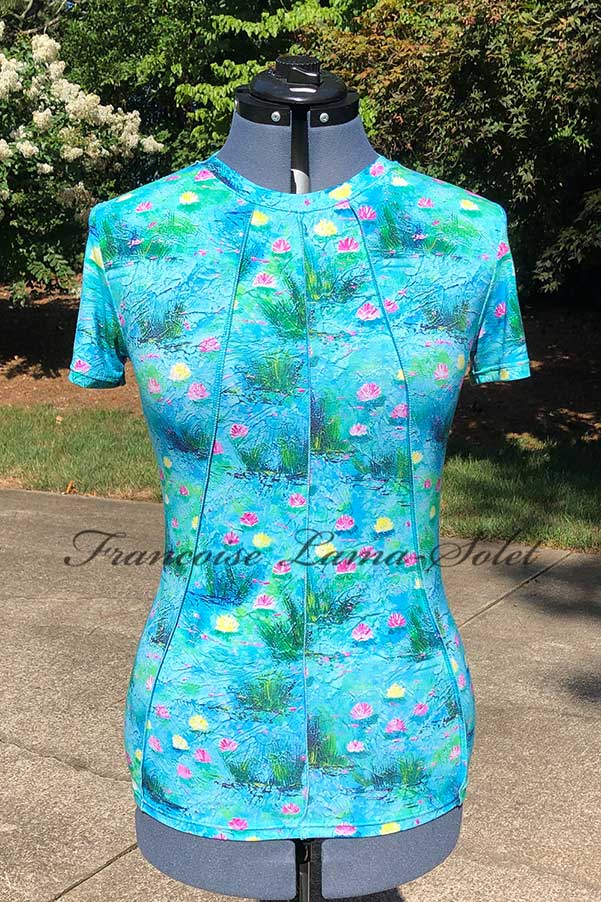 Handmade women's short-sleeve top featuring a vibrant waterlily design with shades of blue, pink, and yellow