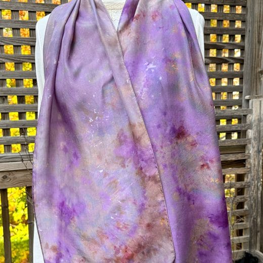Hand-dyed silk scarf in shades of purple, khaki, and pink, featuring unique patterns and soft, versatile fabric.