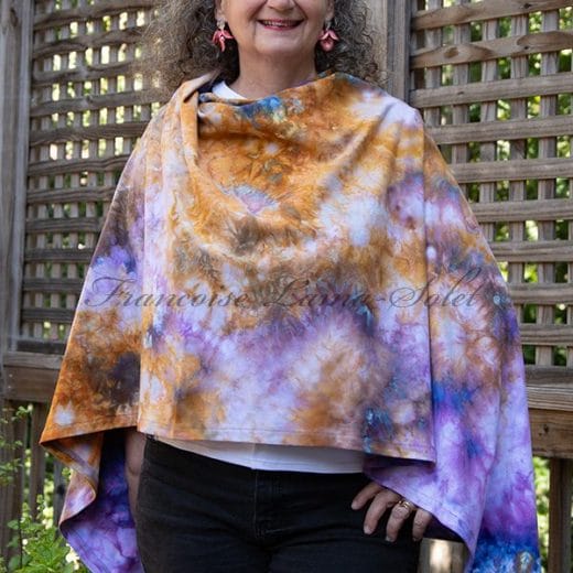 Women handmade and hand dyed poncho in different shades or purple, marigold and blue.