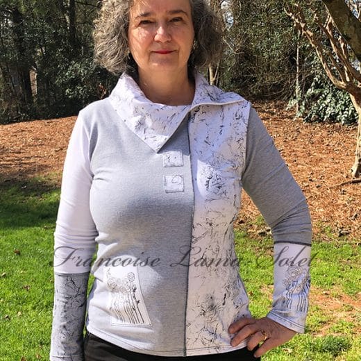 Upgrade your wardrobe with this handmade gray and white long sleeve t-shirt. Unique details and feminine cut make it a fashionable choice for any occasion.
