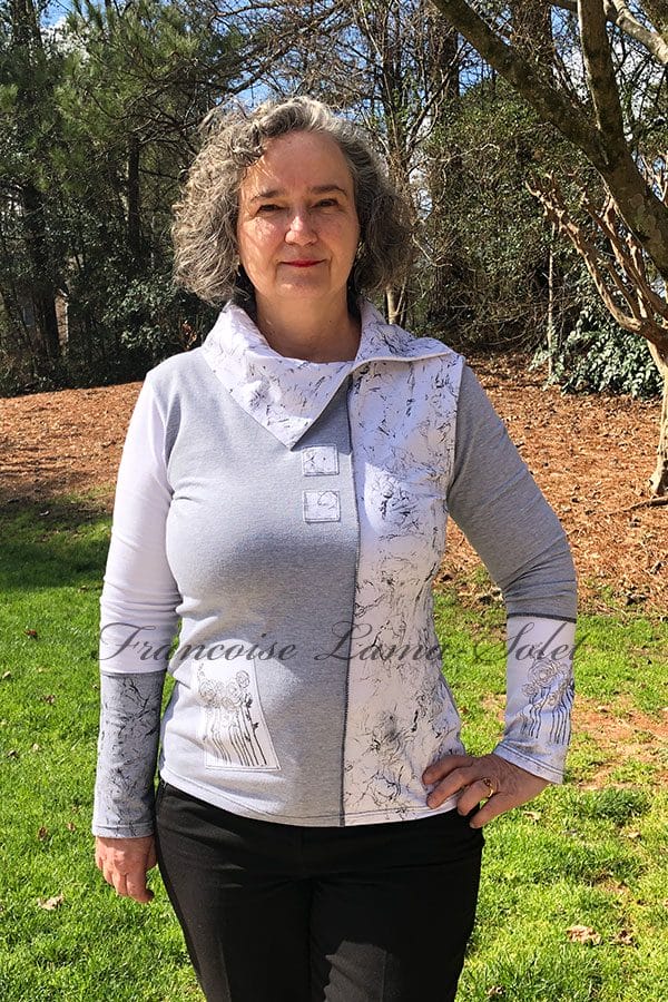 Upgrade your wardrobe with this handmade gray and white long sleeve t-shirt. Unique details and feminine cut make it a fashionable choice for any occasion.