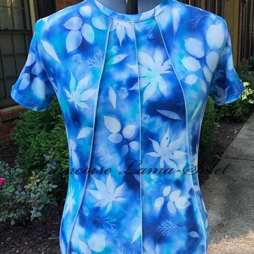 Indulge in the beauty of hand-painted fashion with this unique women's top. The leaf print design and comfortable fabric make it perfect for any occasion.