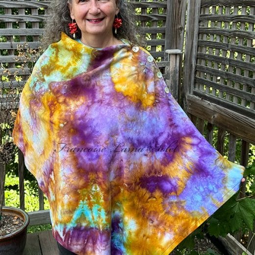 Women's colorful handmade and hand dyed poncho in different shades of marigold, purple and turquoise
