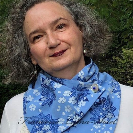 Women's blue button neck scarf handmade and hand printed with cherry blossoms and lotus flowers.