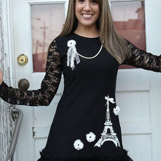 Women's black a-line tunic with lace long sleeves, embellished with an Eiffel Tower print and lace.