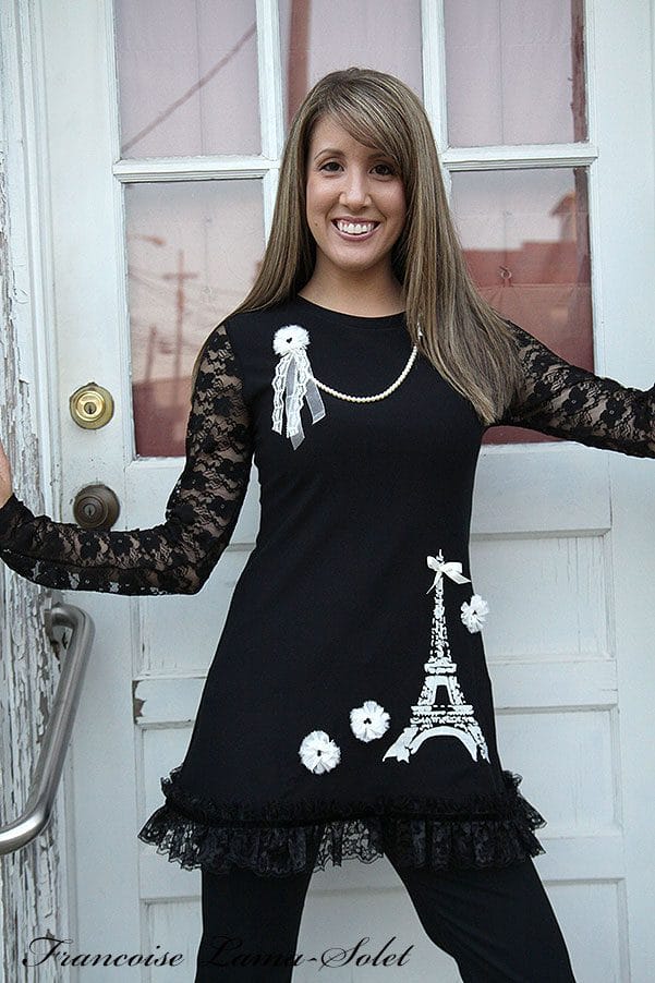 Women's black a-line tunic with lace long sleeves, embellished with an Eiffel Tower print and lace.