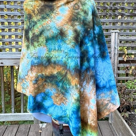 Women's poncho cape handmade and hand ice dyed in different shades of blue, brown gold and green.