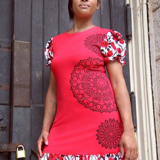 Women's puff sleeve a-line tunic handmade with a red cotton jersey mixed with a floral print, and hand printed with doily patterns.