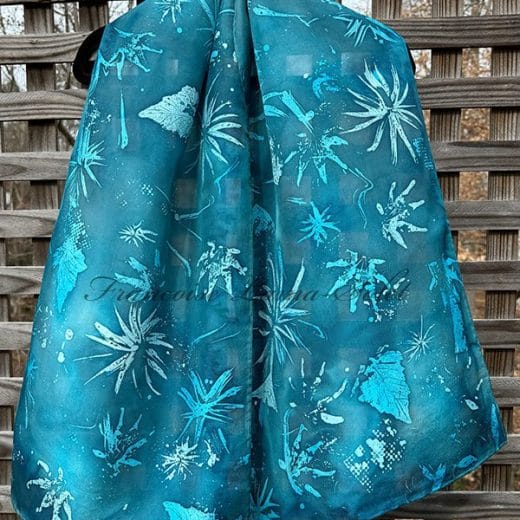 Women's turquoise silk scarf with leaf prints hand painted using batik technique.