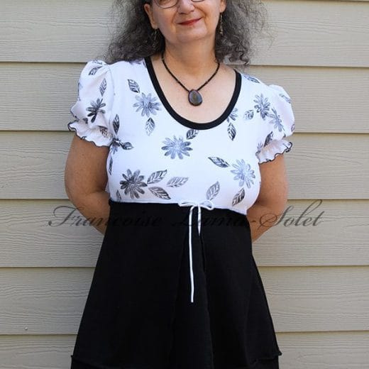 Women empire waist tunic with puff sleeves handmade with a solid black jersey combined with a white jersey that is hand printed with black daisies.