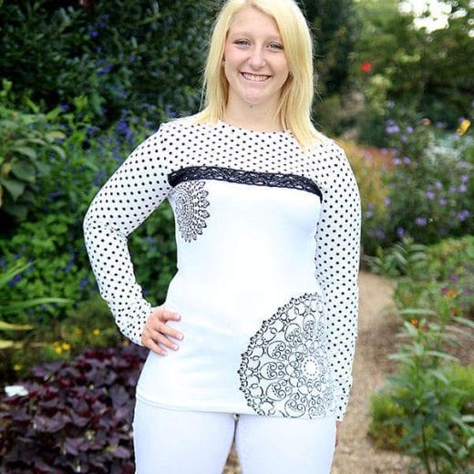 Women's black and white long sleeve t-shirt handmade with a polka dot print and hand printed with white doily patterns.