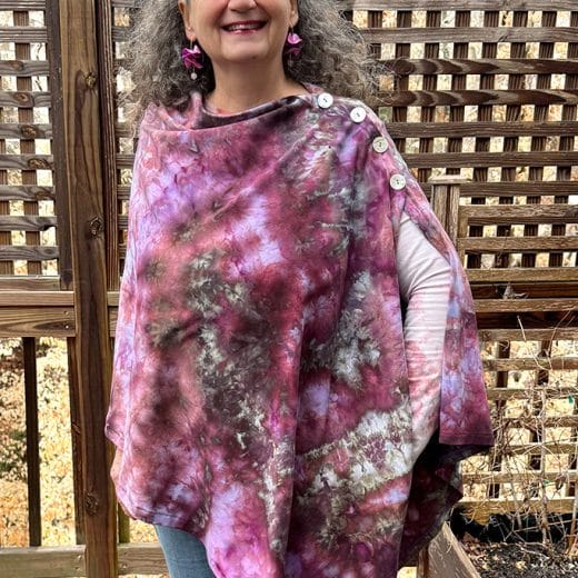 Unique women's handmade and ice dyed poncho cape in different shades of purple and maroon