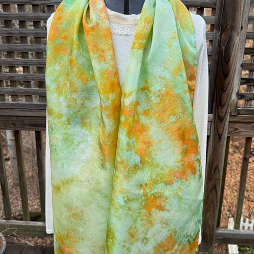 Stunning women's silk scarf hand ice dyed in different shades of green, aqua and orange.