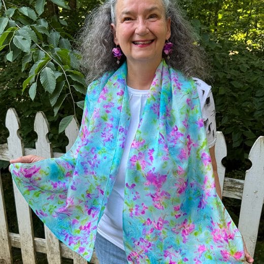 Women's blue and pink wearable art silk scarf hand painted with a cherry blossom pattern