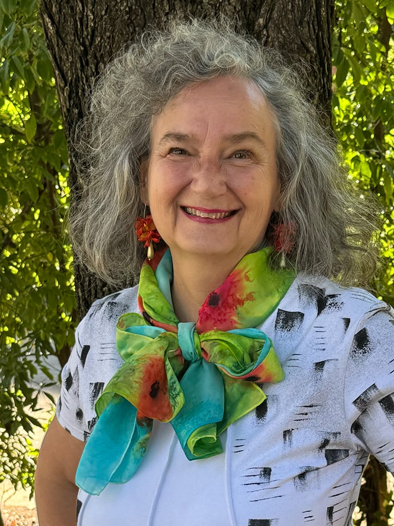 Vibrant hand painted silk scarf featuring red poppies in a field