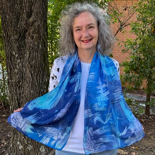 Women's hand painted batik silk scarf in different shades of blues