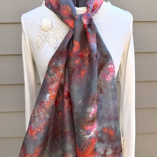Women's wearable art hand ice dyed silk scarf in different shades of orange, grey, brown, green and pink