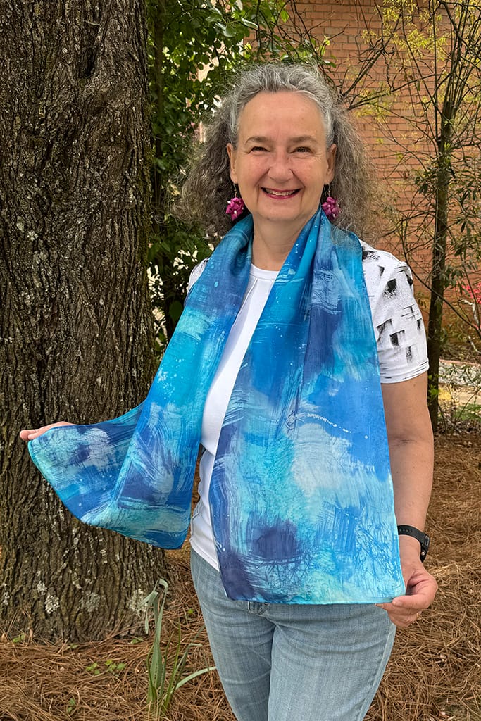 Women's hand painted abstract batik silk scarf in different shades of blues