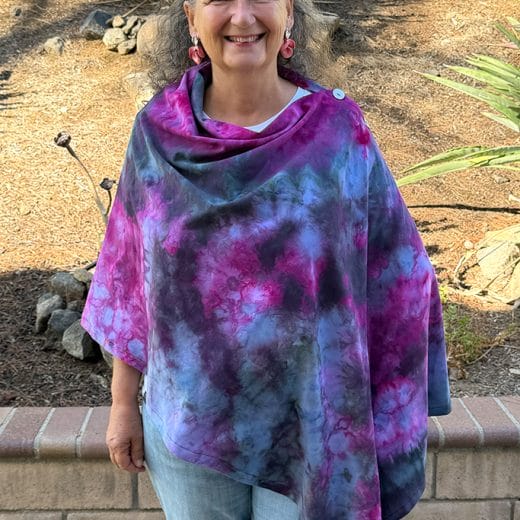 Women's poncho handmade and hand dyed in different shades of pink, purple and black.